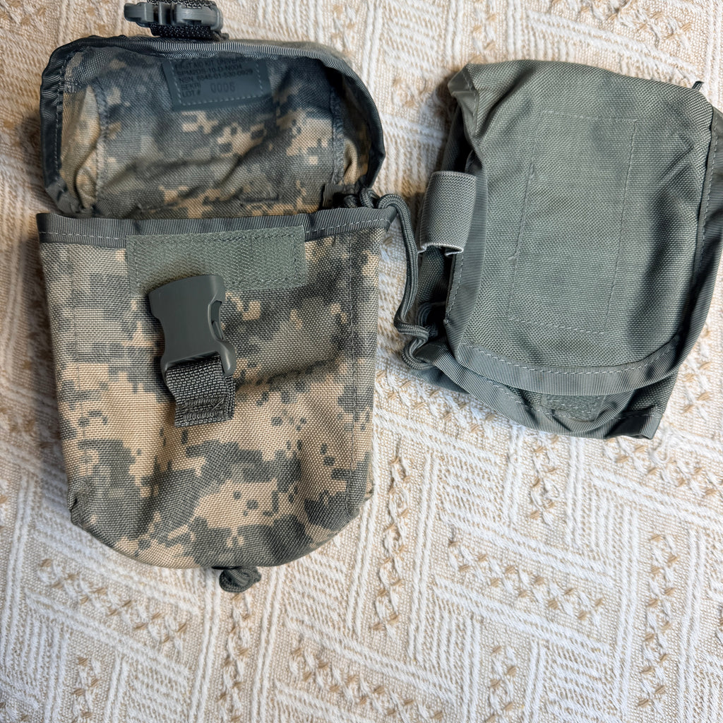 Two tactical utility pouches laid flat on a textured beige woven surface. The left pouch is in digital camouflage with a flap closure and plastic buckle, and the right pouch is solid olive green with a simple flap closure.