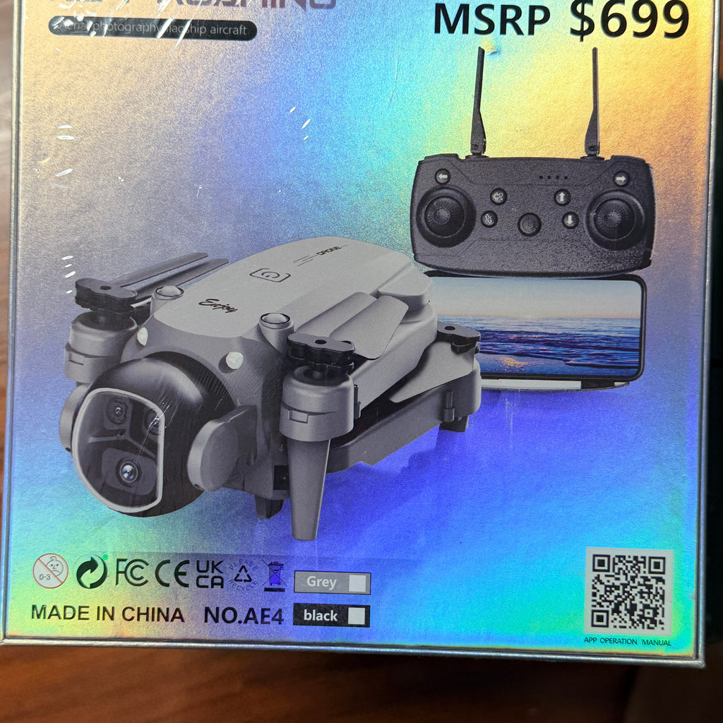 Boxed retail packaging for a foldable drone and its remote controller, shown against a reflective iridescent background with the text 'MSRP $699' and product details including 'Grey' and 'black'.